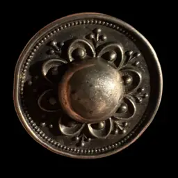 Antique Victorian era ornate metal button or decorative element.