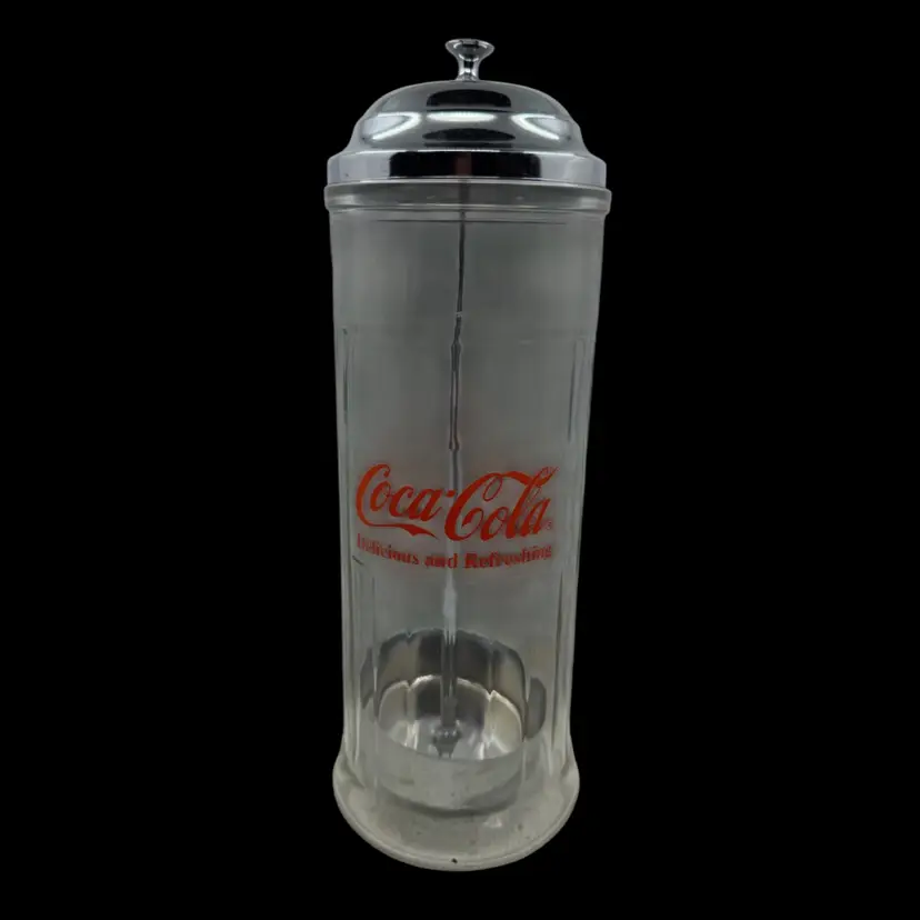 Vintage Coca-Cola glass straw dispenser with chrome lid and red logo. 1992