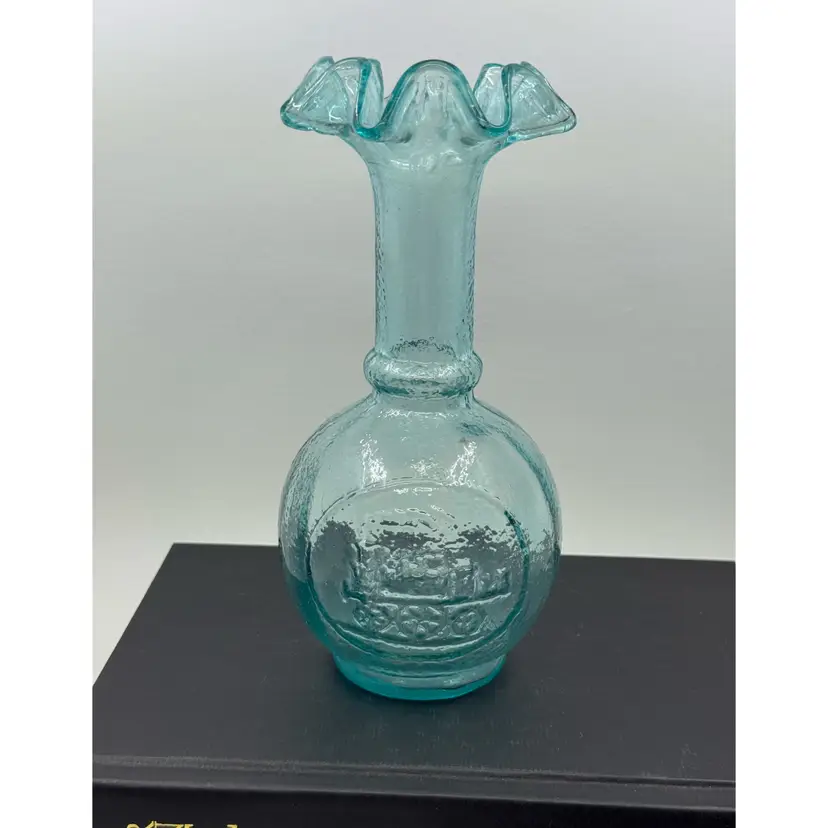 A vintage blue textured glass vase with a ruffled rim and train embossment, Glower