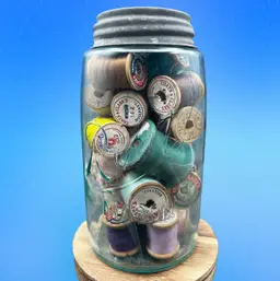 #182A Please Read - Vintage Blue Root Mason Jar With Zinc Lid Filled With Wood Thread Spool, Both With And Without Thread. 
Jar Has A Crack Around The Neck And Will Only Ship On Request, Knowing I Cannot Guarantee It Won’t Break. Spools Will Be Removed And Packaged In A Manner To Keep Them Clean And Safe