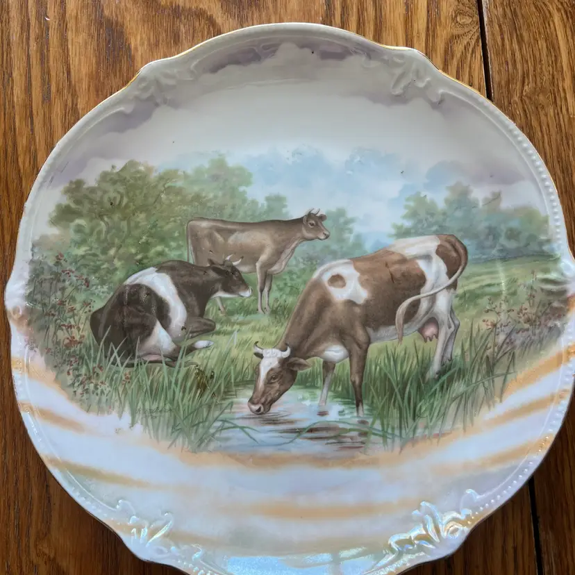 Antique hand-painted porcelain plate with a pastoral cow scene.12” - Marked Germany On Back
