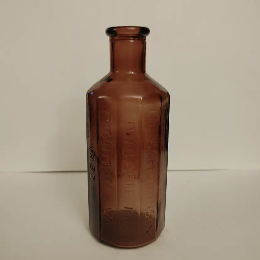 Wheaton reproduction Amethyst tinted bottle from the 1970's. Bottle says Col Sam Johnson, Proprietor, 1852, Jaundice Bitters. Made in Taiwan. 6 inches tall. No chips or cracks.
