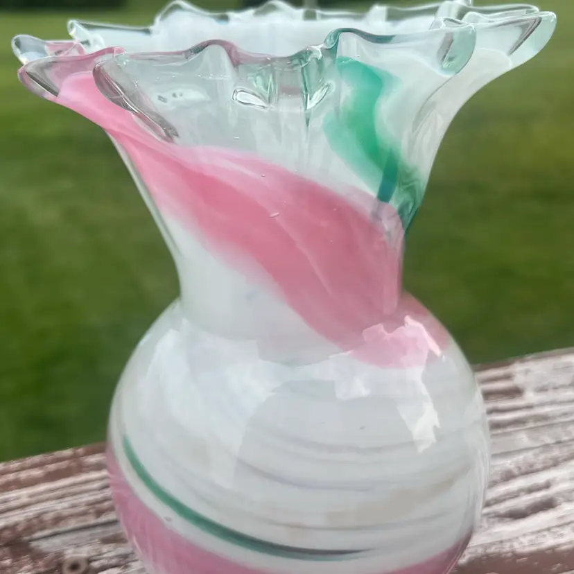 Hand-blown art glass vase with pink and green swirls and ruffled rim. Likely Made By Ozark glass.  6.5” X 5” Wide