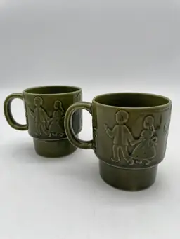 Set Of 2 Vintage Green Glazed Ceramic Stacking Mugs With Kids Holding Hands