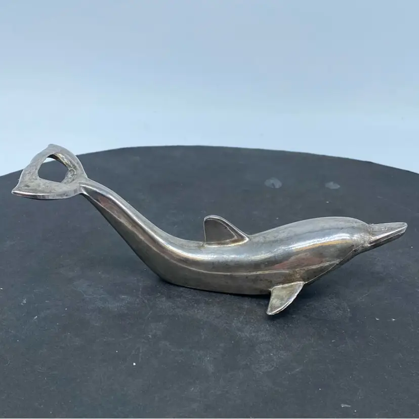 #1327 A vintage silver-plated metal dolphin-shaped bottle opener.