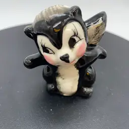 #1412 A whimsical vintage ceramic skunk figurine with painted Tail