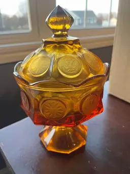 Fostoria amber glass lidded bowl in the iconic Coin Glass pattern. Circa 1950s.8.5” Tall 5 inches wide