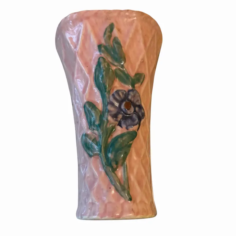 This is a vintage Morton Pottery ceramic wall pocket featuring a pink basketweave pattern and a floral design