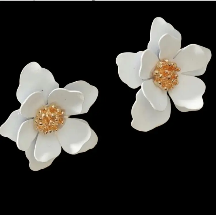 White Flower Stud Earrings With Gold Accents half inch in length.