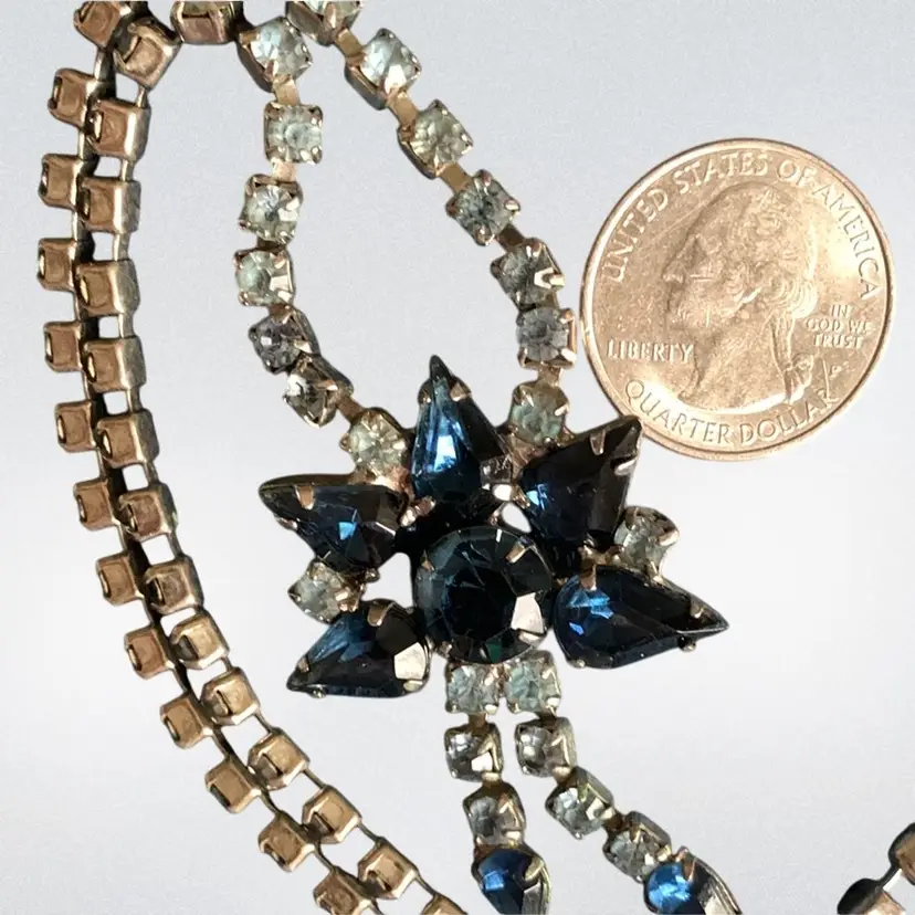 Light and Dark Blue Rhinestone Flower Dangle Necklace. Hook Closure. Light blue rhinestones on the chain, dark blue rhinestone flower