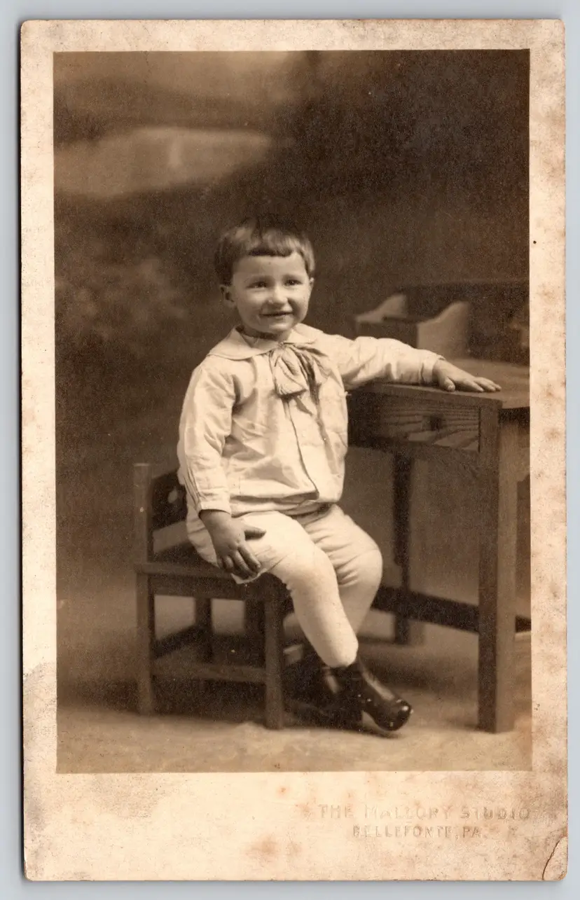 Postcard RPPC Young Smiling Child Seated at Desk Real Photo - 8885