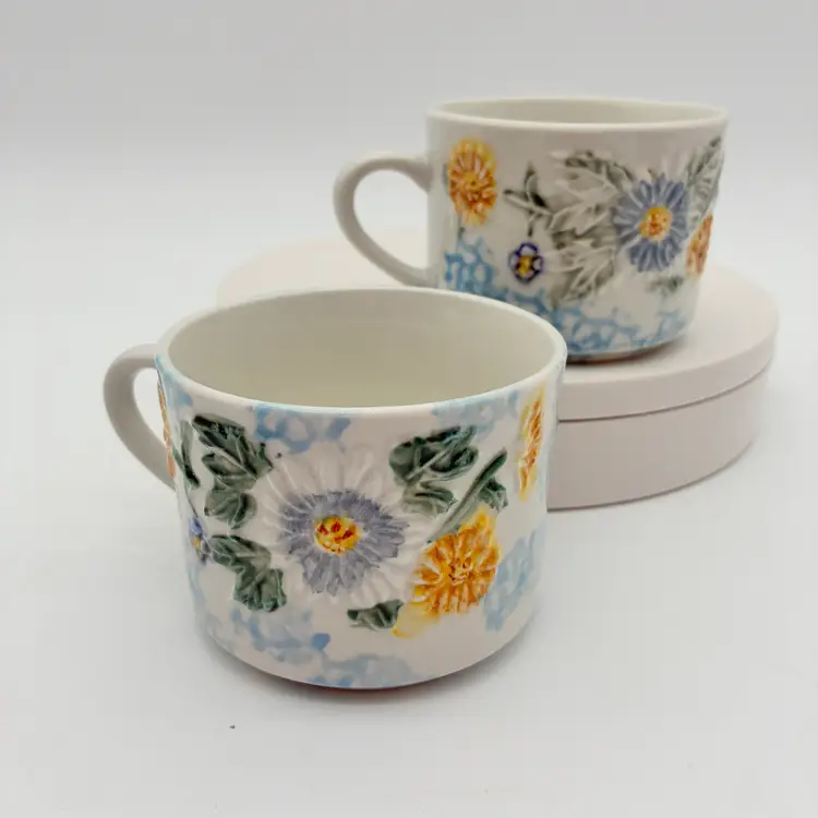 Daisy Patch Tabletops Unlimited 2 Floral Embossed Ceramic Mugs Blue Yellow White