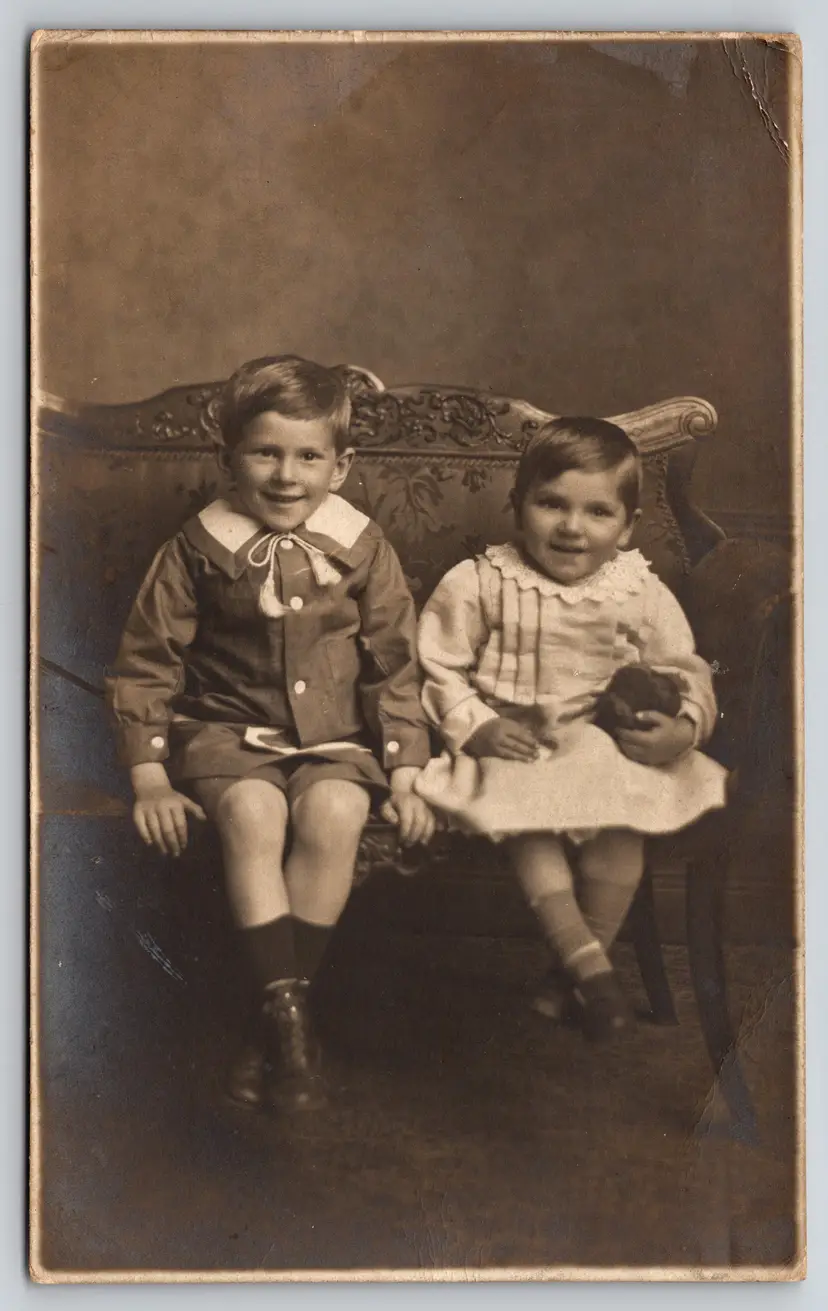 Postcard RPPC Seated Children Brother and Sister Real Photo Girl Holding Stuff - 8879