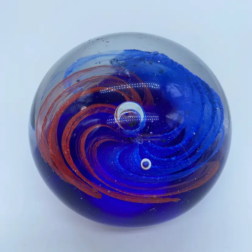 #0047 A vintage Bohemian glass paperweight with a blue and red spiral design.