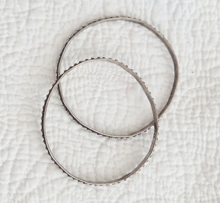 Pair of Vintage Signed Mexican Sterling Silver Bangle Bracelets with an Embossed Petite Floral Design