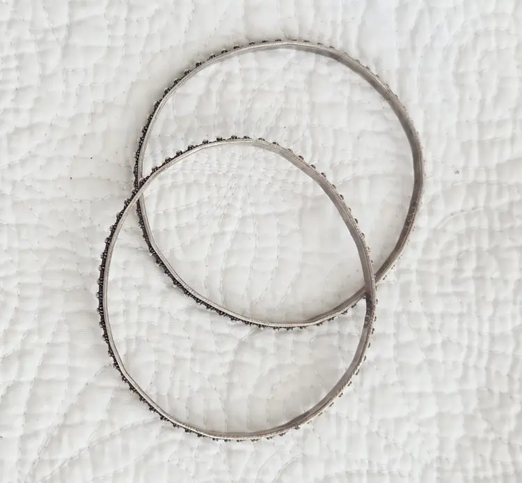 Pair of Vintage Signed Mexican Sterling Silver Bangle Bracelets with an Embossed Petite Floral Design