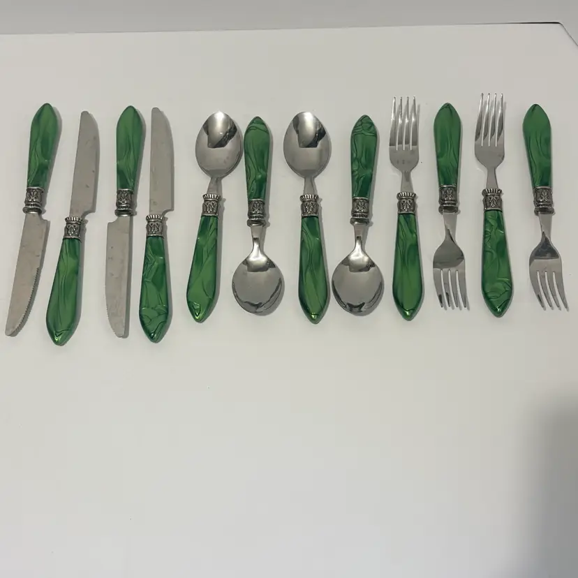Decorative Art Nouveau style stainless steel flatware set with green marbled resin handles and ornate ferrules. service for 4, spoon, fork, & knife