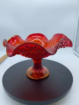 #1009 Fenton hobnail Amberina glass compote with a ruffled edge.