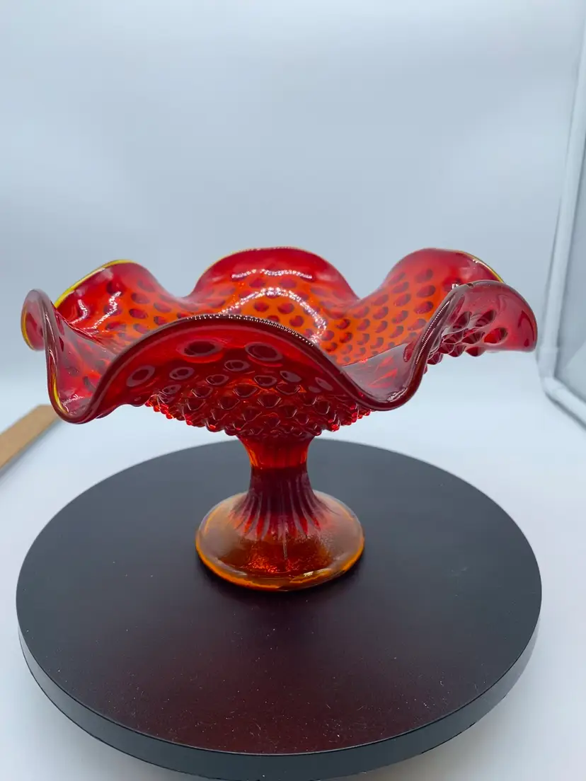 #1009 Fenton hobnail Amberina glass compote with a ruffled edge.