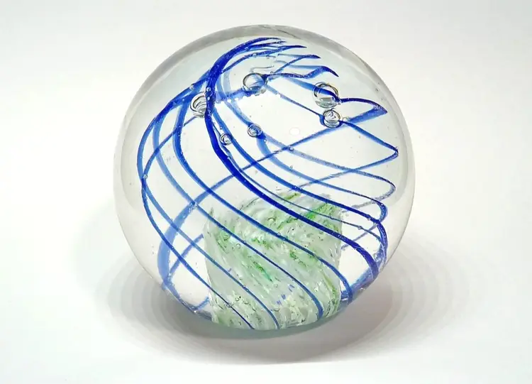 Art Glass Paperweight Sphere Blue Swirl Green & White Center Bubbles 2½"   Clear glass with blue swirls.  Green & white center.  Bubbles.  Unmarked.  Aprox 2½" tall.  No chips or cracks.