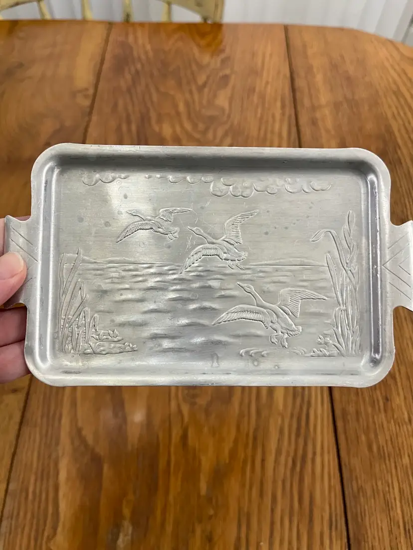 #01 Vintage embossed aluminum tray with flying geese and reeds. 7.5x4.5”