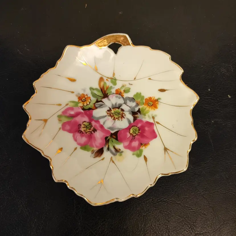 Leaf shaped trinket dish with flowers. Made in Japan. No chips or cracks. 5 x 5.