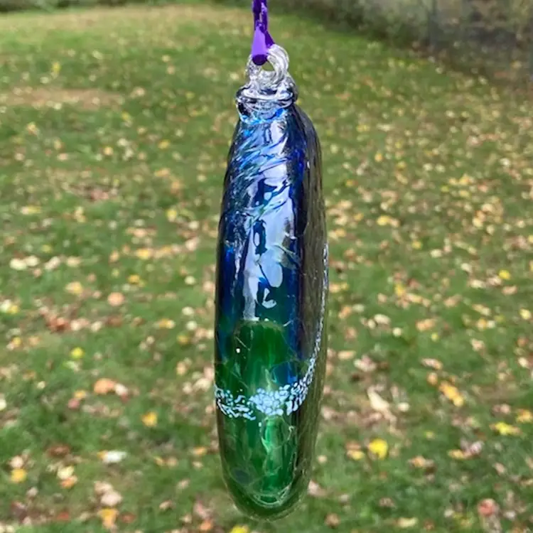 Blue, Green And White, Flat Hand-Blown Glass Ornament With Hanger & Purple Ribbon. 5.25”w x 6.25”h (including hanger) x .75”d. Not Signed.