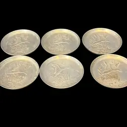 Vintage hammered aluminum coaster with embossed duck and marsh scene. 3.25”