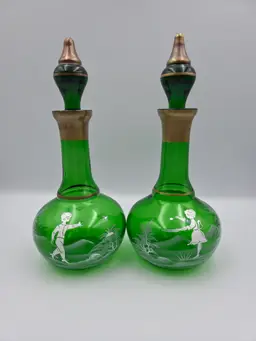 Pair of Mary Gregory Painted Green Glass Decanters with Gold Trim