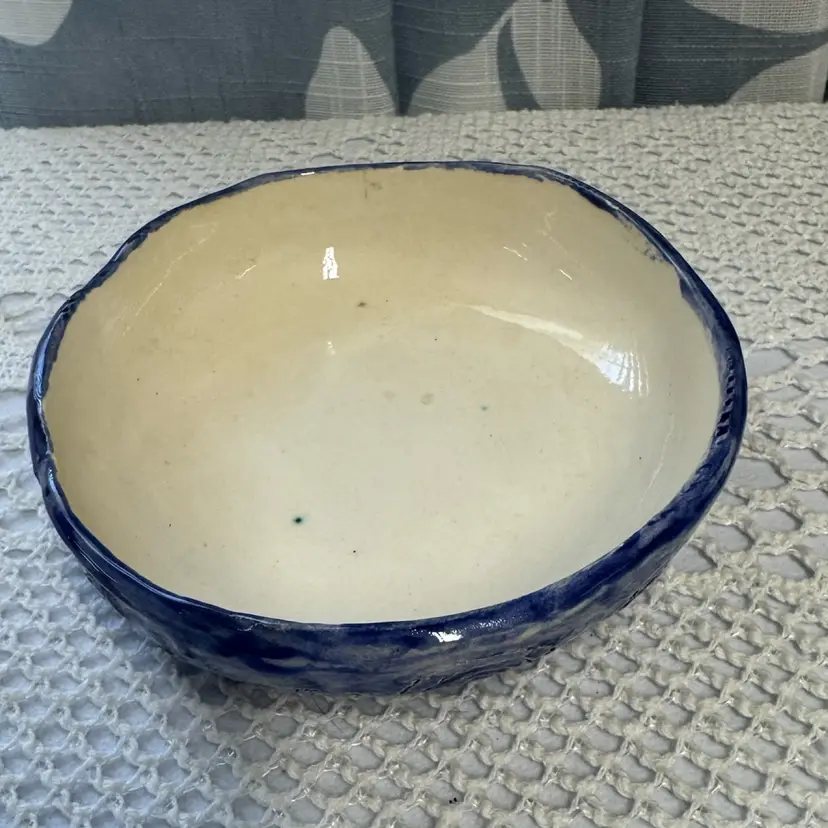 Shallow Pottery Bowl With Blue Exterior And Swirl Design