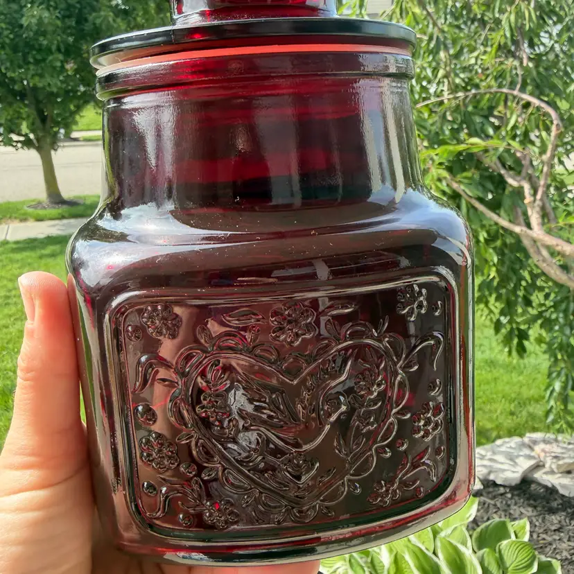 Wheaton ruby red glass jar with embossed heart Fish and floral designs. 8”