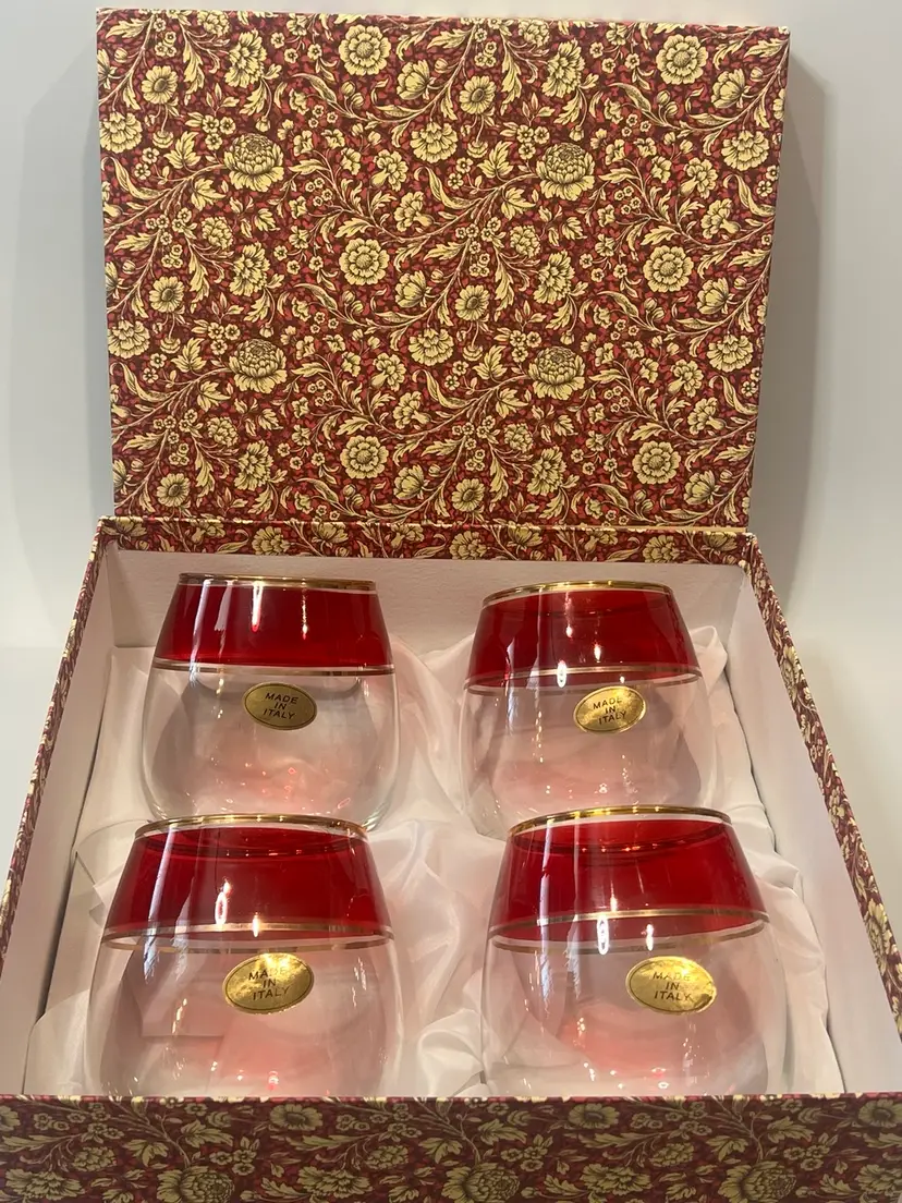 Z- Hand Blown Italian Wine Glasses  Vintage Roly Poly Stemless.   Set Of 4 New In Box! 

Lovely Hand Blown Italian Wine Glasses
Roly Poly....Stemless.
I Tried To Show The Mark On The Bottom!   
Condition is New with stickers and In Box.  
60 year old vintage and nice.
Lovely hand blown clear glass with a red band and 22k gold trim.
They are about 4 1/2in tall and 4in wide.
They hold 16oz!   Cheers! 
I will ship with the ultimate care, and if you happen to be a recharge for shipping tremendously, I will gladly give you a credit as no one likes to be overcharged for shipping. Thank you for shopping Vintage & Vino!