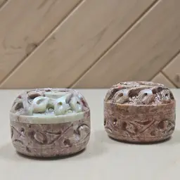Pair of hand-carved soapstone trinket boxes with tops featuring carved flowers