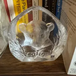 #01 - Mats Jonasson crystal paperweight featuring a lion or tiger Adult Mats Jonasson is a renowned Swedish glass artist known for his detailed, engraved lead crystal sculptures of wildlife.