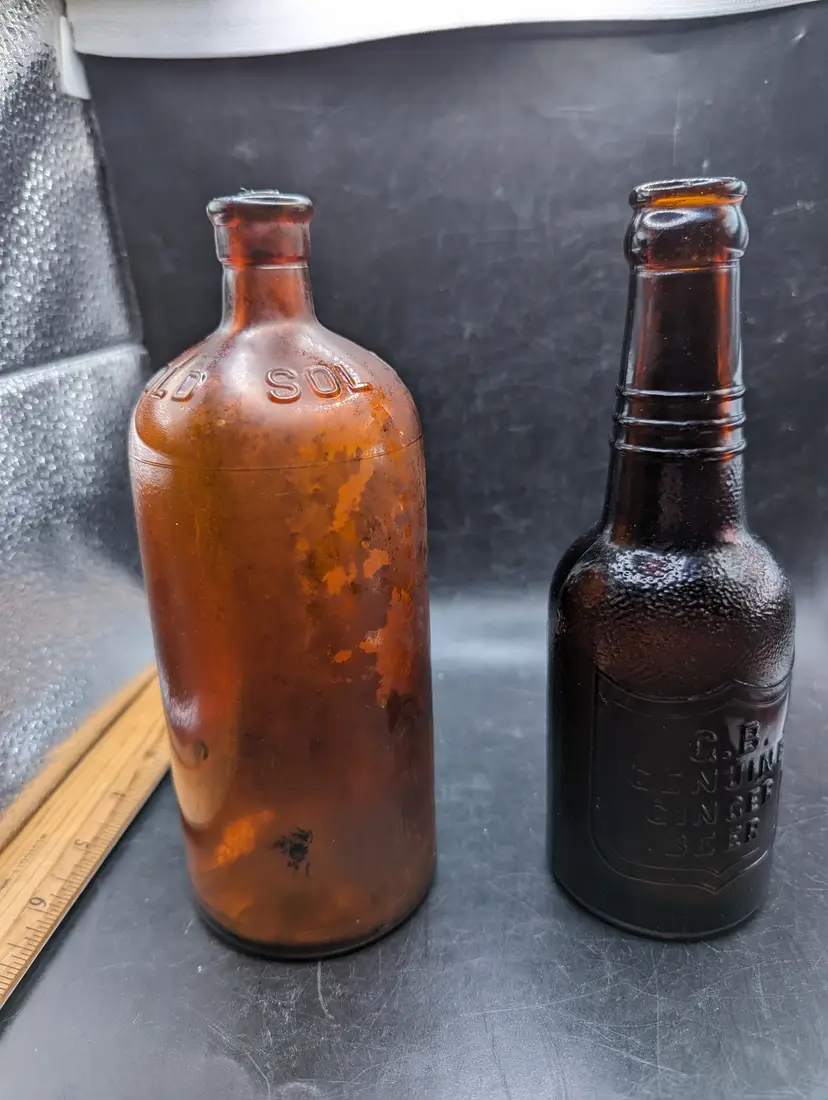 Lot of 2 Vintage Brown Bottles One G B Genuine Ginger Beer and One Old Soldier Cleans All With Original Cork.