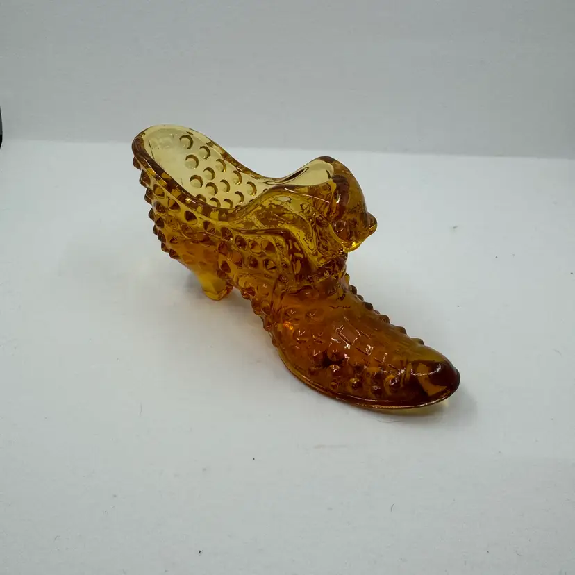 Vintage Fenton amber hobnail glass slipper with a cat's head.