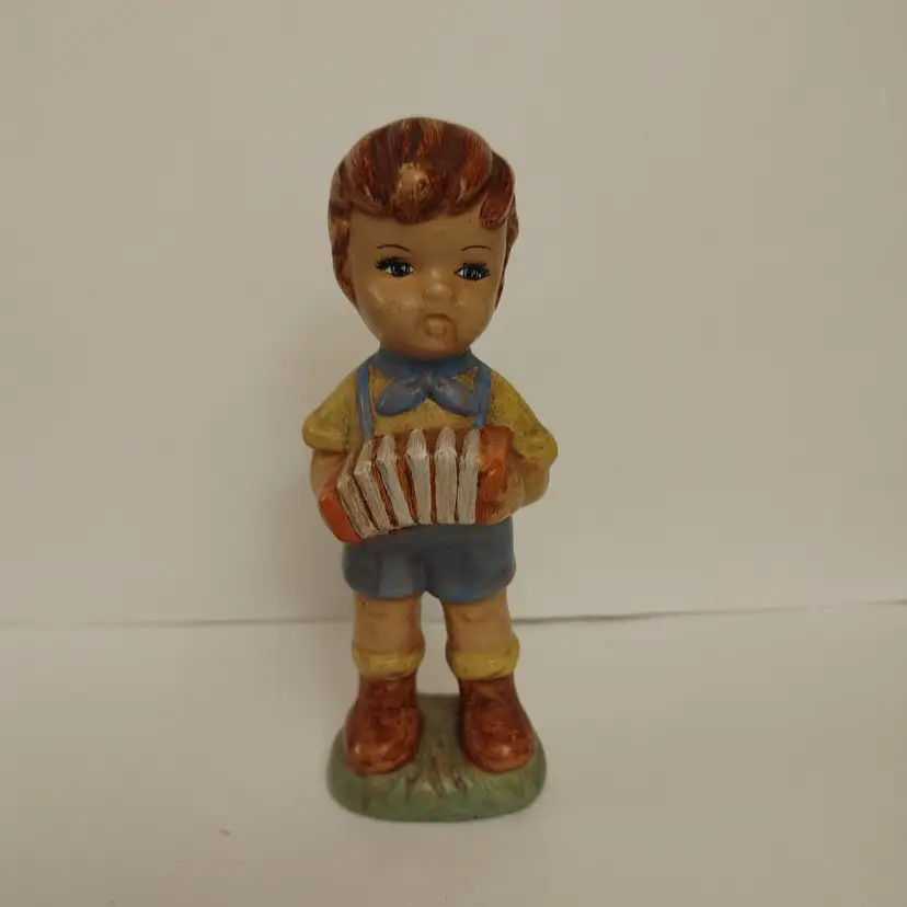 Boy Figurine with Accordion. Signed Margie. No chips. 5.5 inches high.