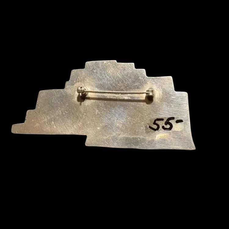Vintage sterling silver pueblo village brooch with geometric architectural details.