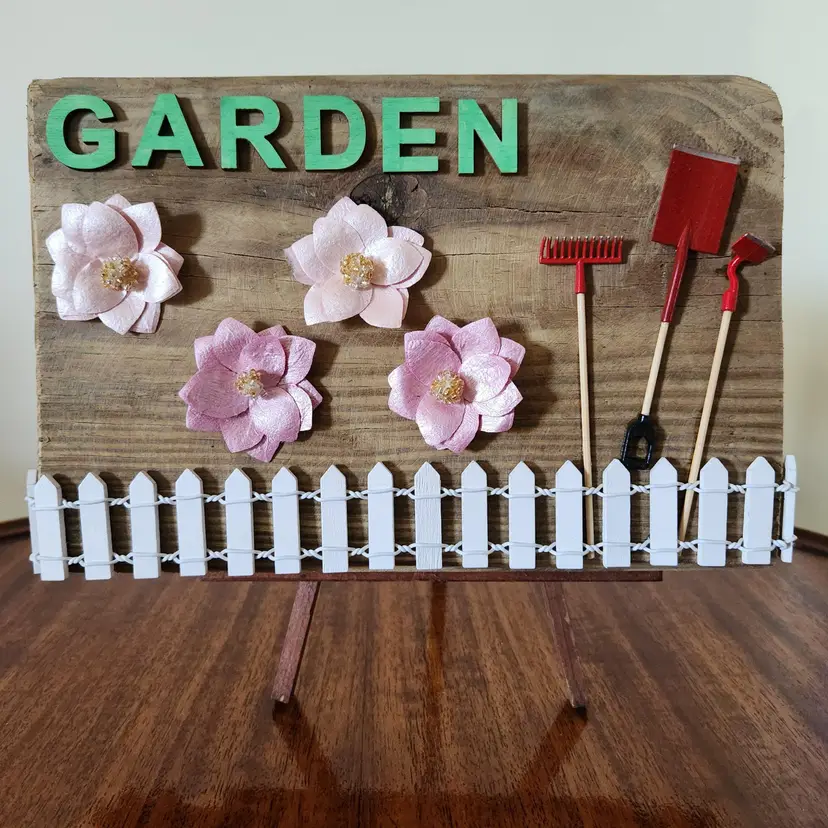 Garden Theme On Reclaimed Wood With Fence, Flowers & Miniature Shovel, Hoe And Rake, Original, 3-dimensional, One Of A Kind Piece, Handmade With Hook On Back For Hanging And Felt Pads To Protect Your Walls. Stand Not Included. 9"x5.5"x1".