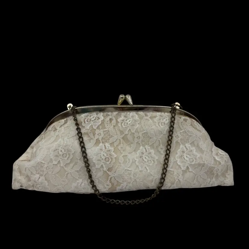Vintage white lace clutch purse with metal frame and chain strap.