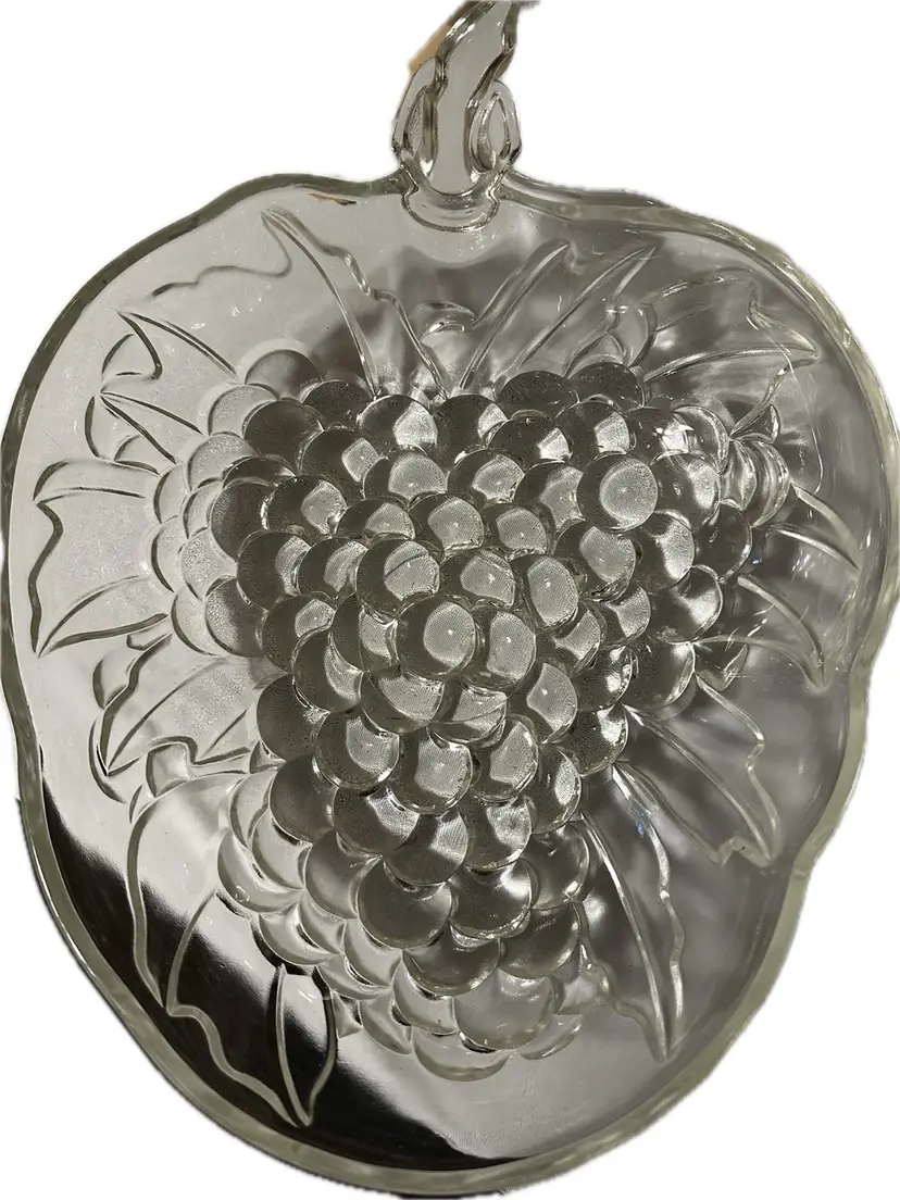 This vintage Indiana Glass fruit bowl features a raised grape cluster pattern with a stem handle