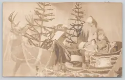 Postcard RPPC Child with Budget Santa Claus, Reindeer, and Sleigh - Toy Doll - Studio Portrait - 9965
