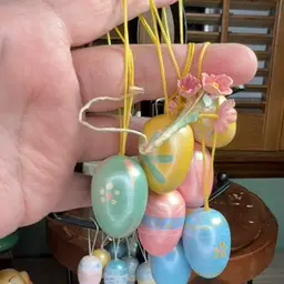 8 Eggs Pastel Colors On Yellow Cord