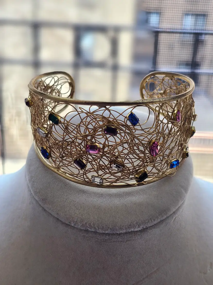 GOLD-TONE METAL  cuff bracelet adorned with multicolored Swarovski crystals.