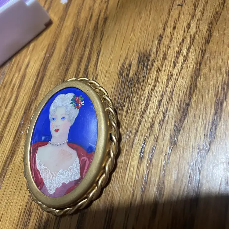 Antique hand painted portrait pin in twisted edge brass frame