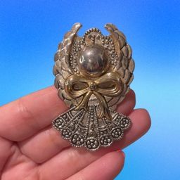23. Silver and gold tone, angel, brooch, or pendant.