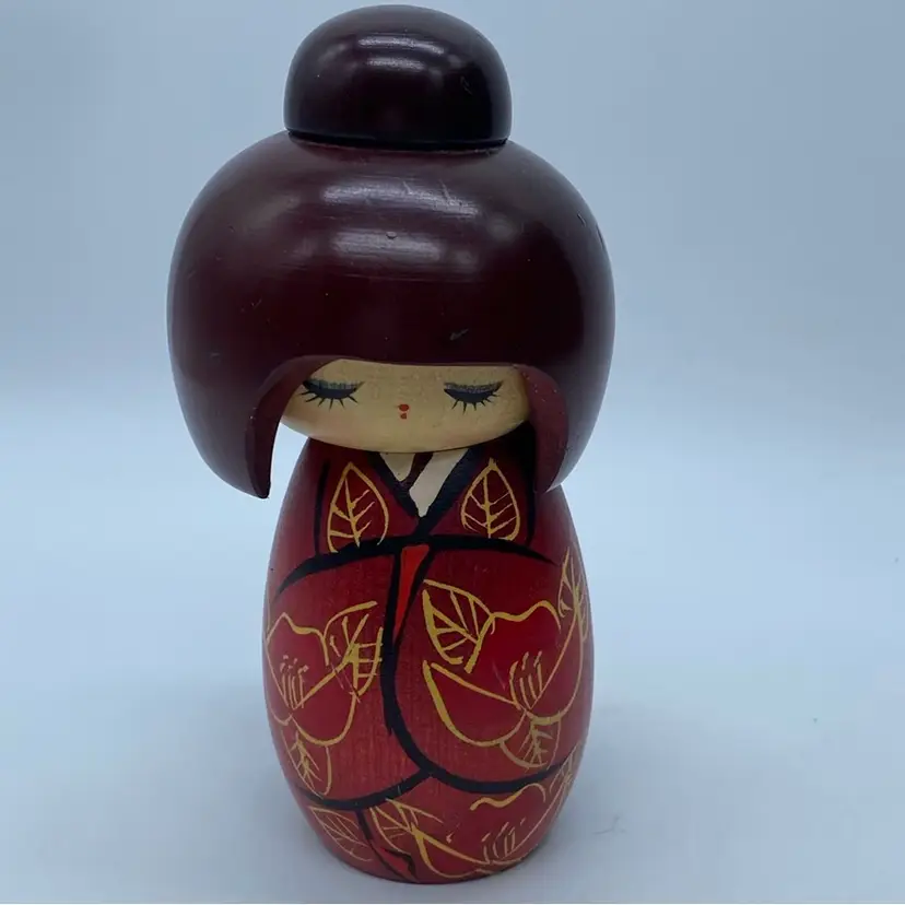 #5111 Hand-painted wooden Kokeshi doll with red kimono and floral design.