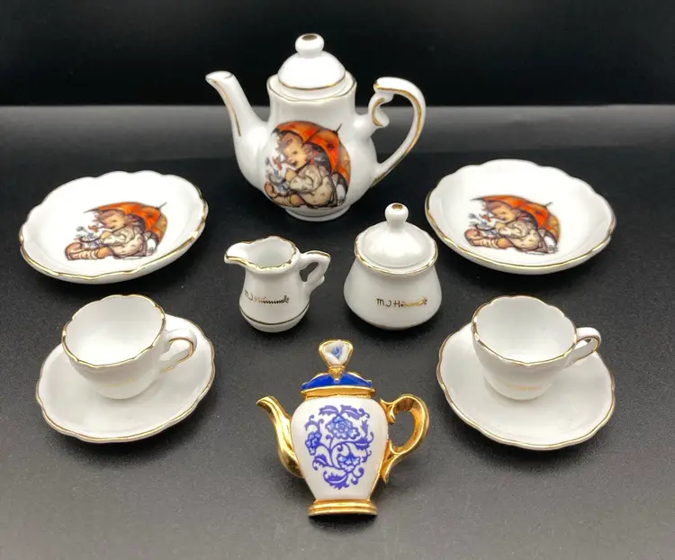 Tea For Two Miniatures Vignette!  MJ Hummel Porcelain Umbrella Girl Made In Germany Teapot And 2 Saucers (Teapot 2 1/2” T X 2 1/2” W Saucers 2” Diameter) Creamer, Sugar, 2 Tea Cups 2 Saucers & Vintage Blue And White Floral Motif Teapot Pin  By Avon (1 1/4” T 1 1/2” W)
