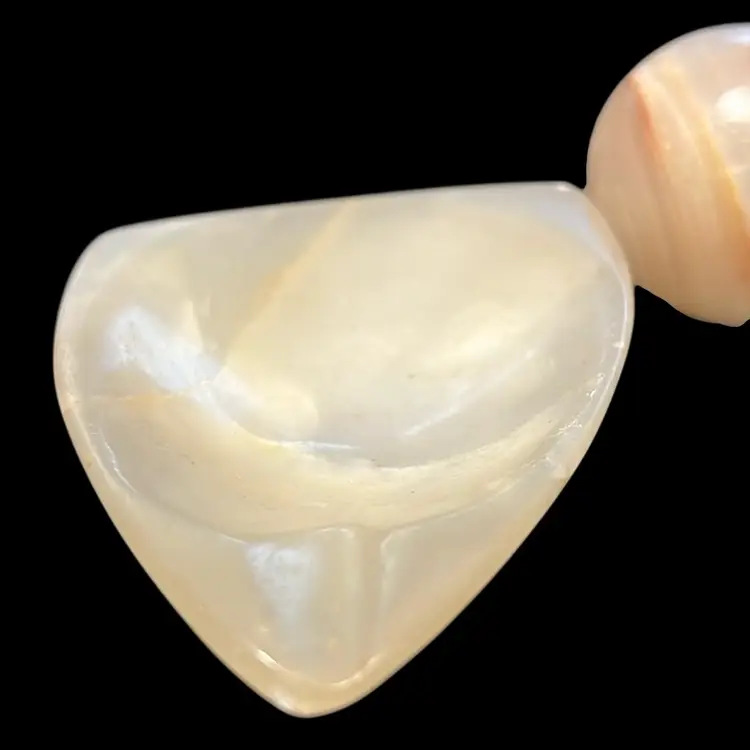 A polished banded agate stone set in a triangular base Approximately 4” Long