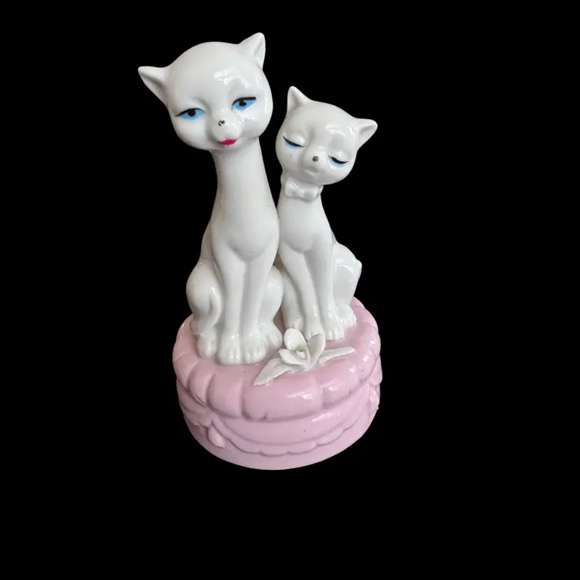 Vintage ceramic music box With Anthropomorphic white cats on a pink base.
